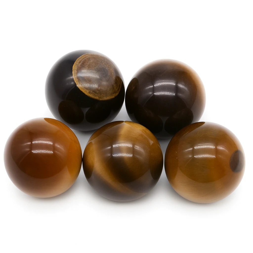 Five brown and black marbles on a white background