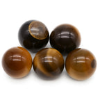 Five brown and black marbles on a white background