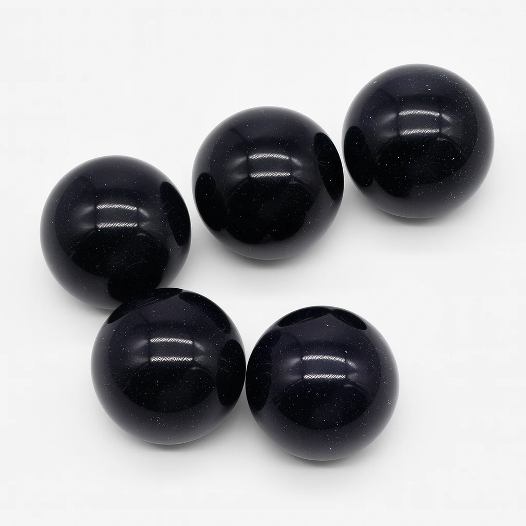 Five black beads on a white background