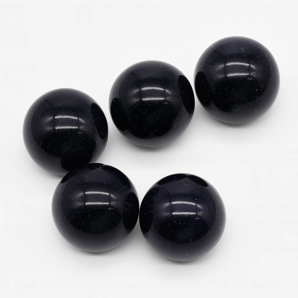 Five black beads on a white background