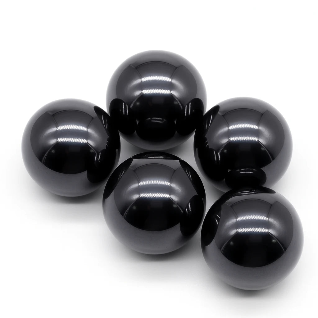Five glossy black spheres on a white background
