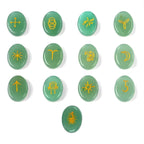 Set of green stones with yellow symbols on a white background