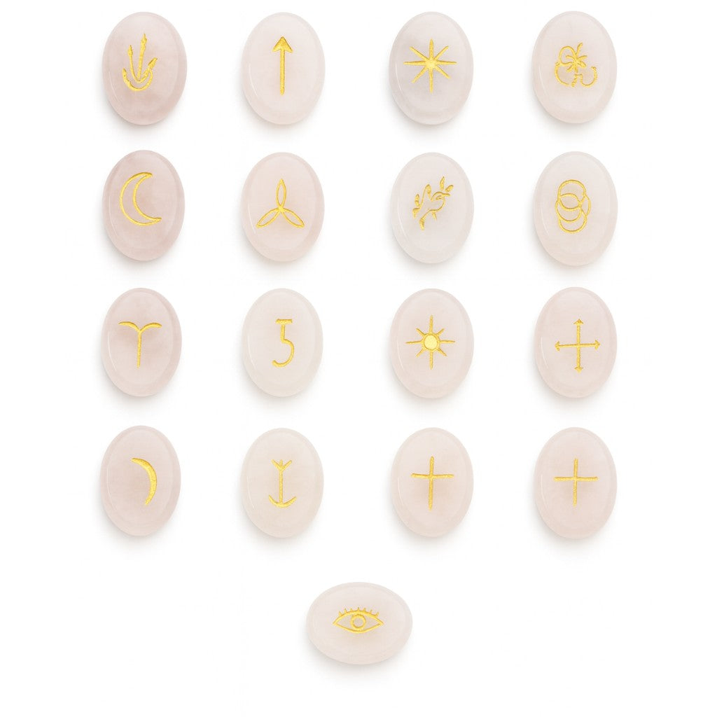 Set of pink stones with gold astrological symbols on a white background