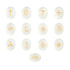 Set of white stones with gold symbols on a white background