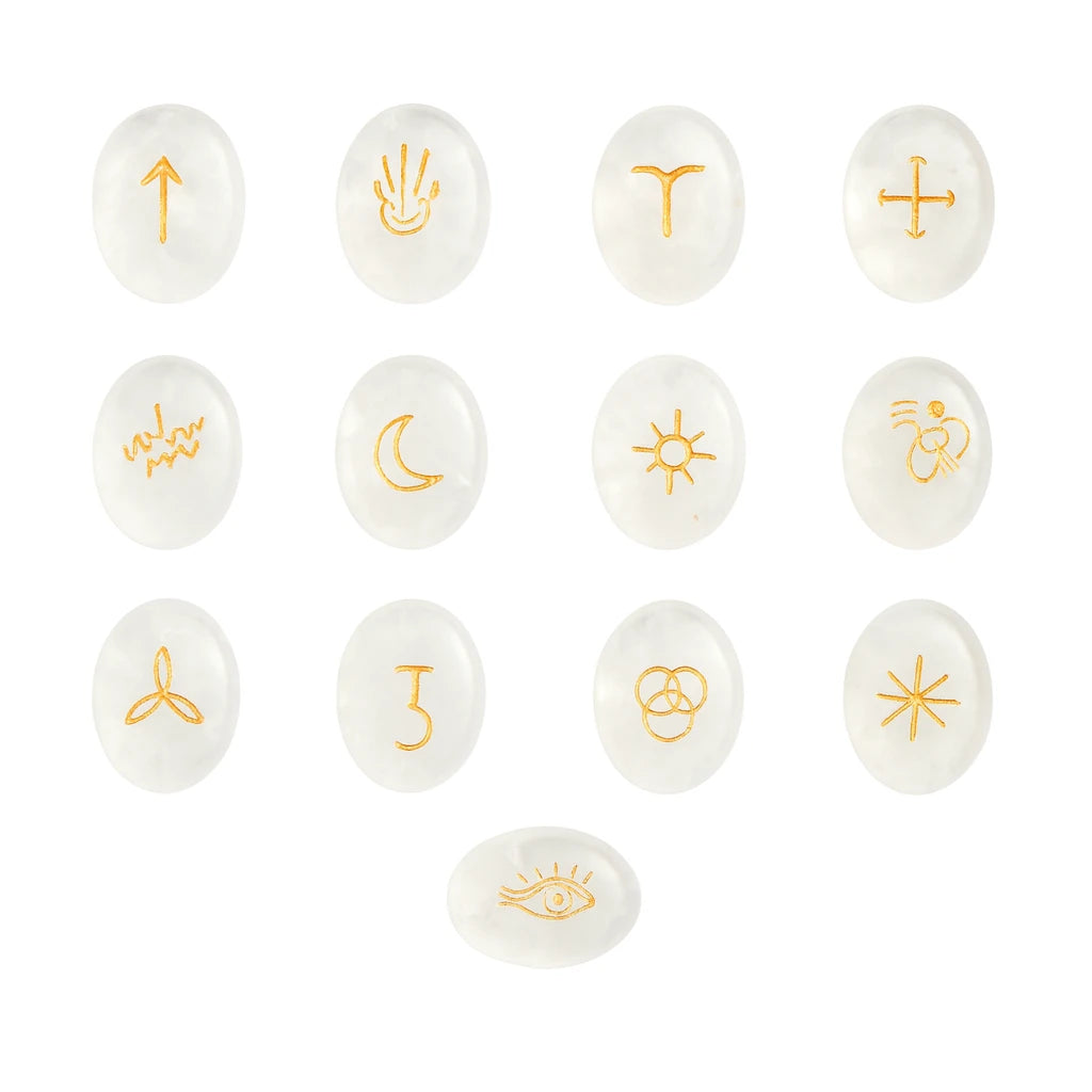 Set of white stones with gold symbols on a white background