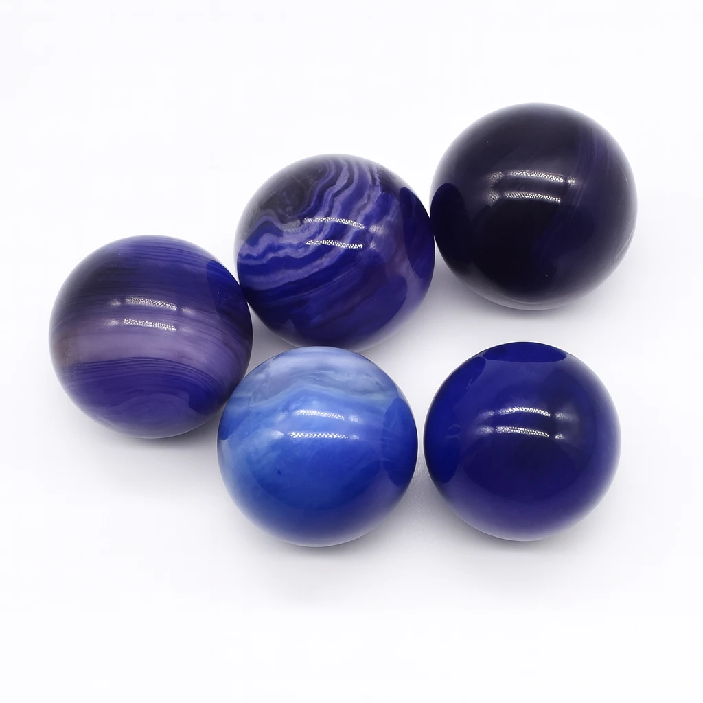 Set of five blue marbled balls on a white background