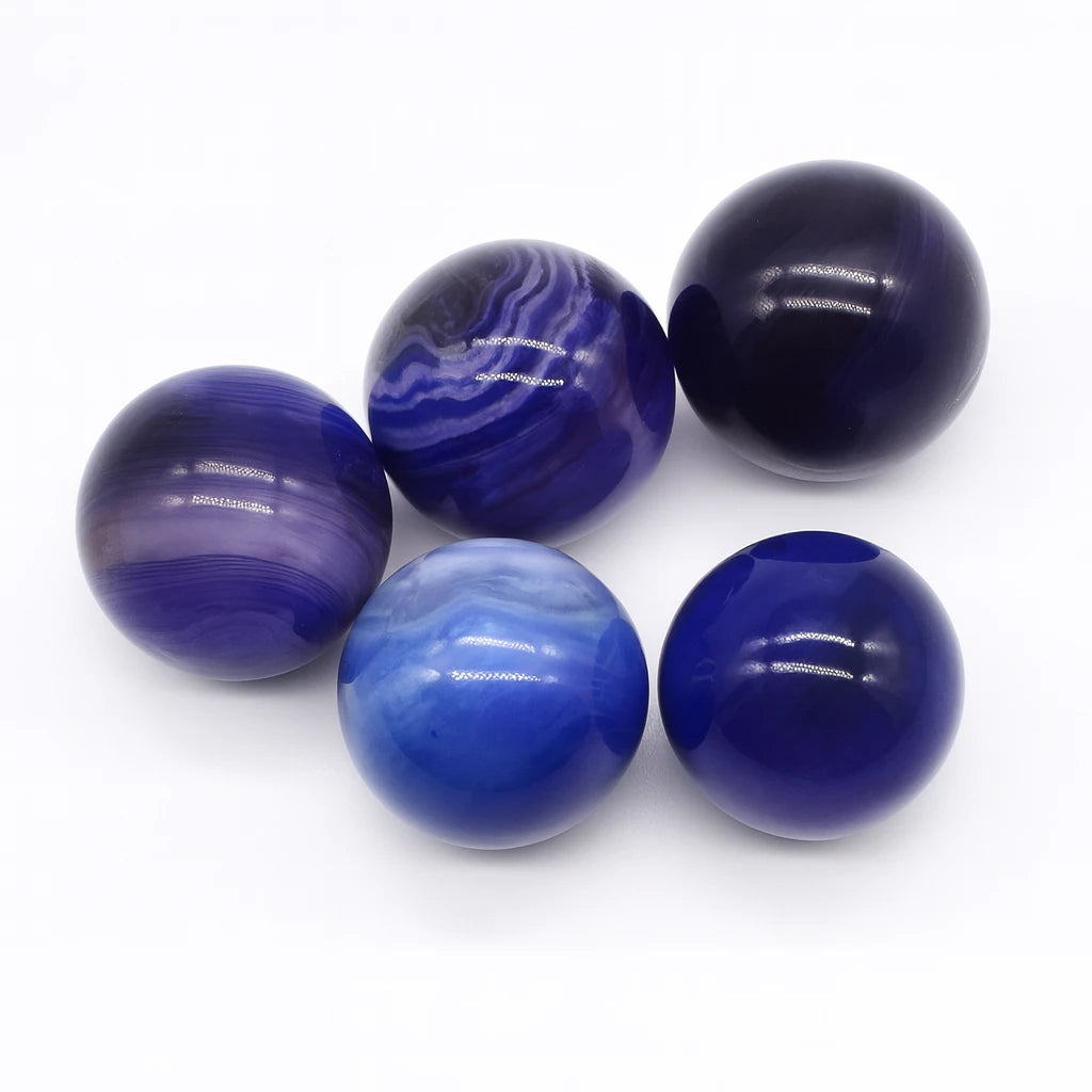 Set of five blue marbled balls on a white background