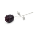 Purple rose with silver stem and leaves on a white background