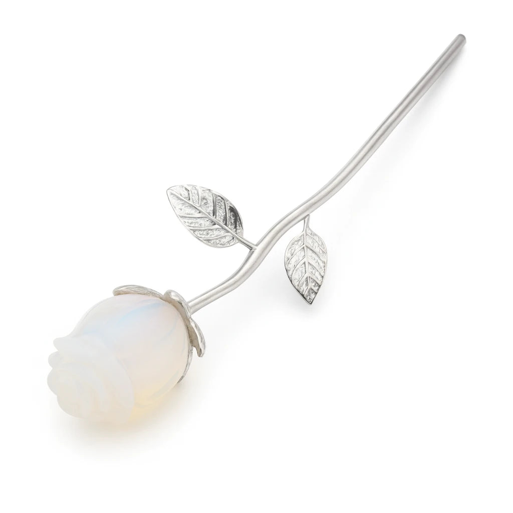 Silver rose with a white stone on a white background