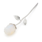 Silver rose with a white stone on a white background