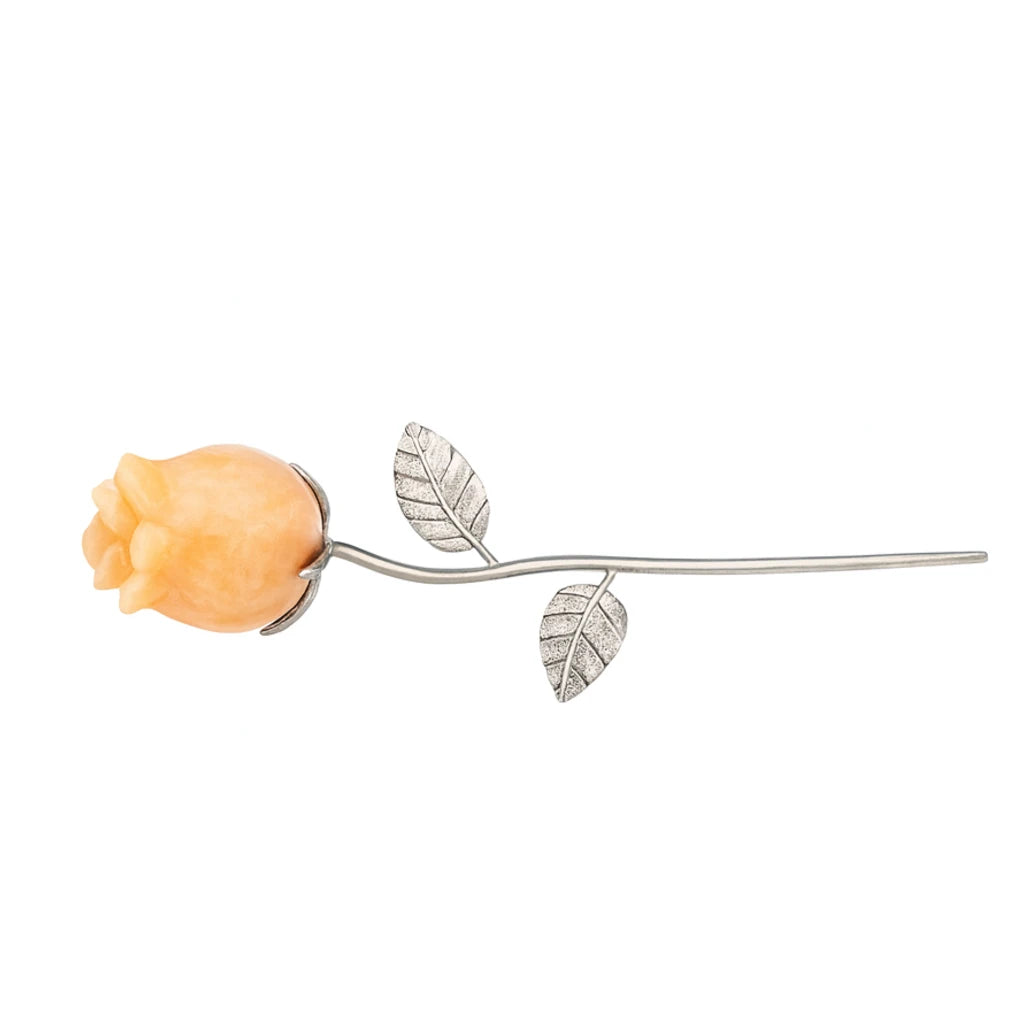 Decorative item with peach-colored rosebud and silver leaves on a white background