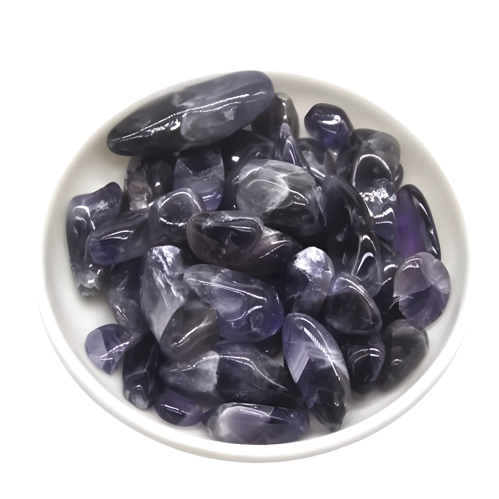 Purple crystals in a white bowl on a white background