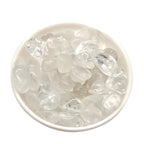 Clear stone chips in a white bowl on a white background