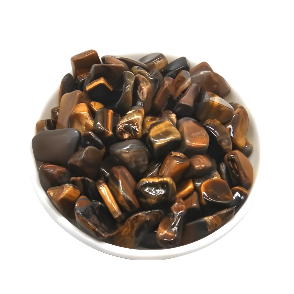 Tumbled tiger eye stones in a white bowl on a white background