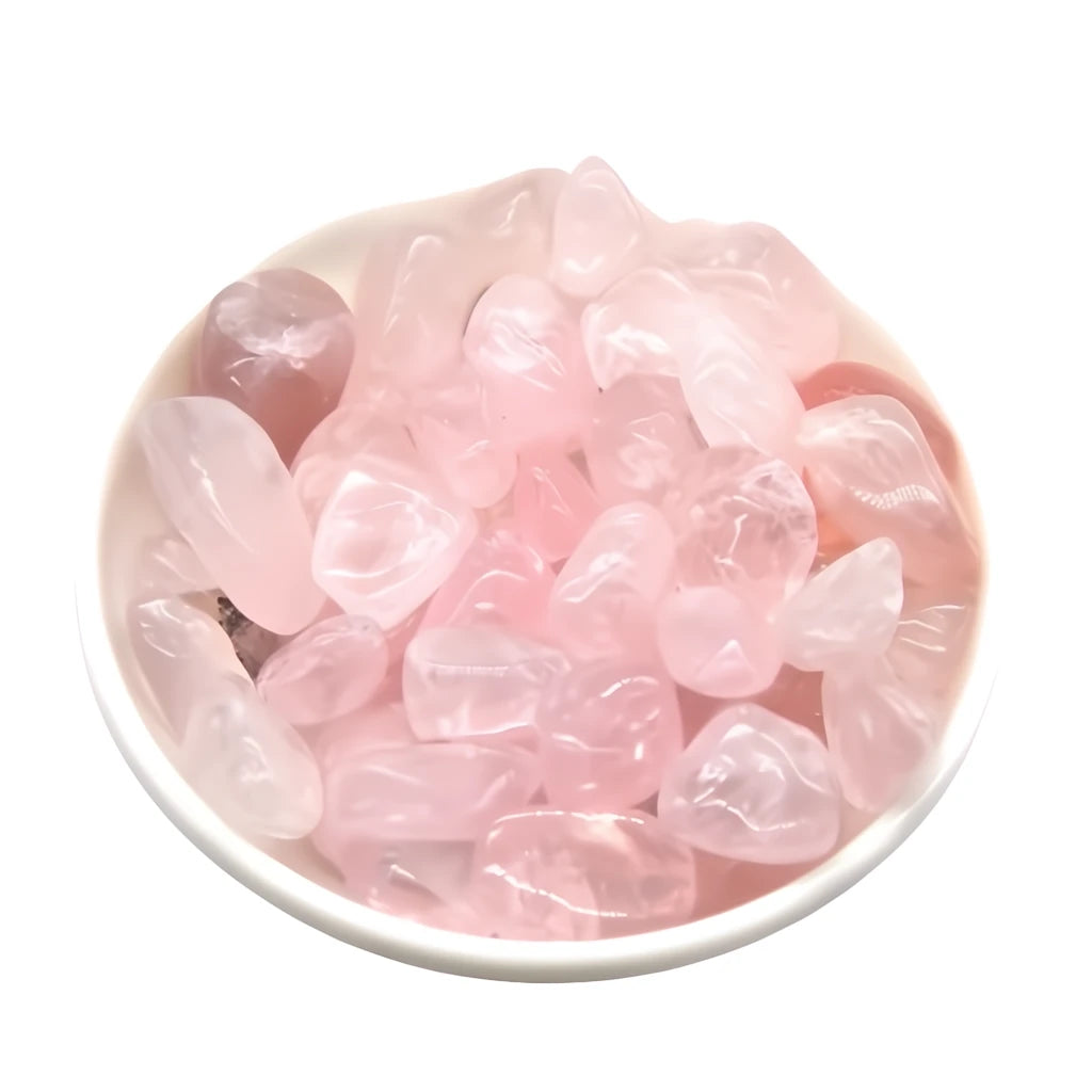 Pink crystal stones in a white bowl on a white background