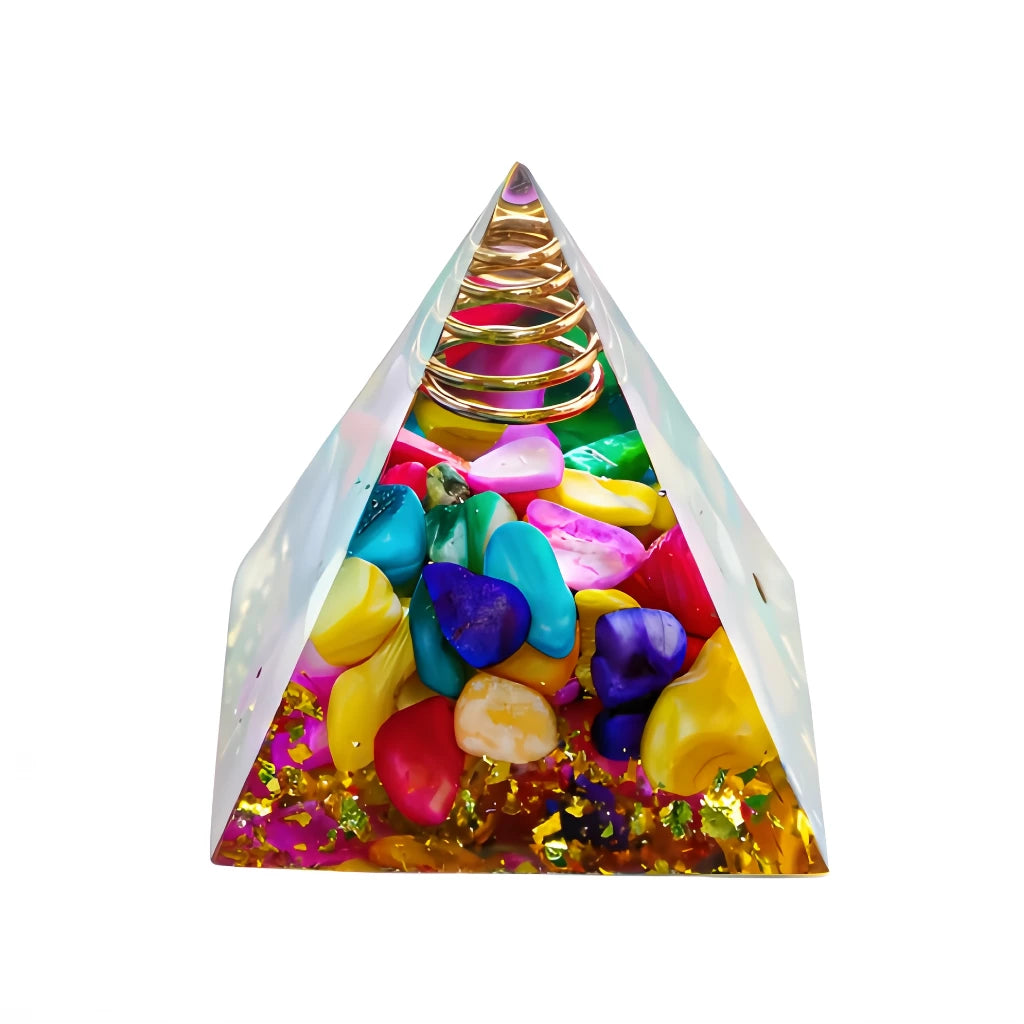 Pyramid-shaped object with colorful stones and a gold spiral on a white background
