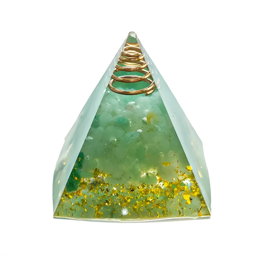 Green pyramid-shaped object with gold flakes and a gold coil on a white background