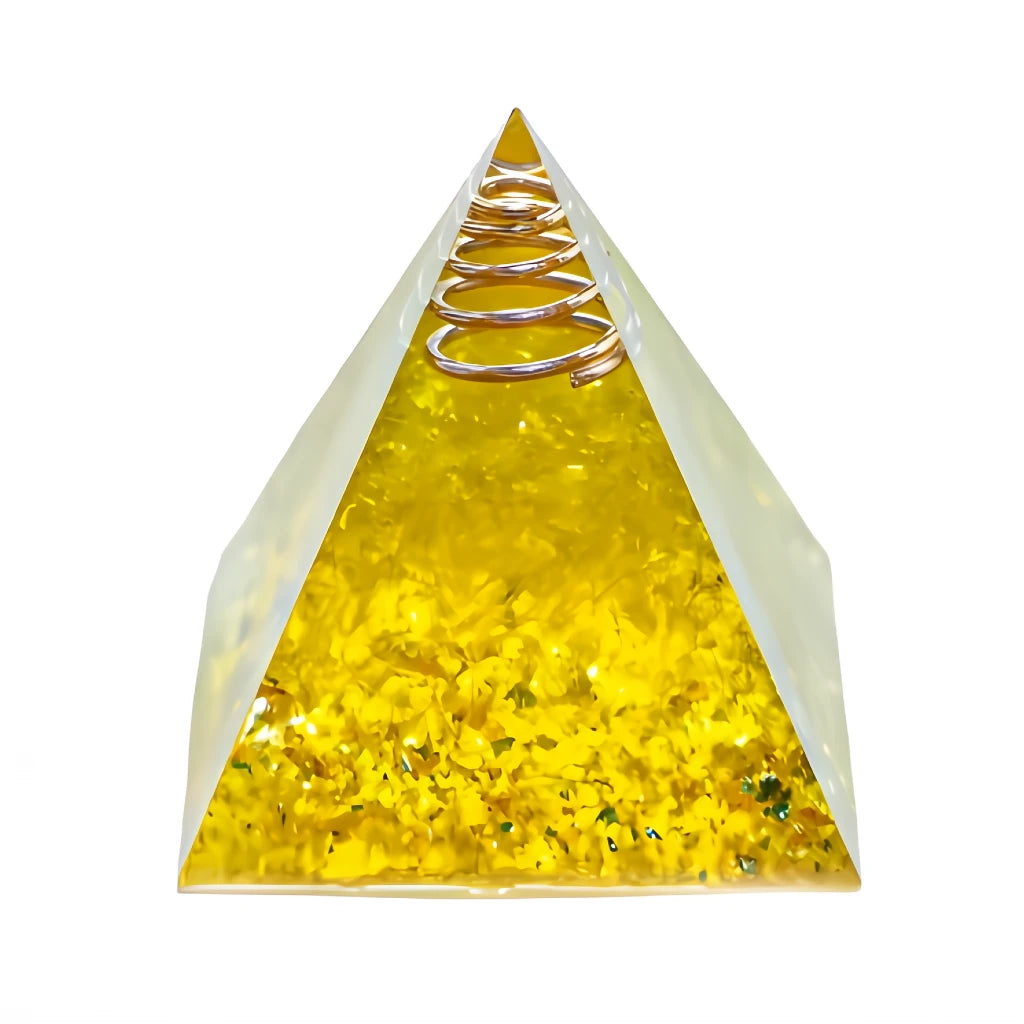 Pyramid-shaped object with a spring on top, filled with yellow material, on a white background
