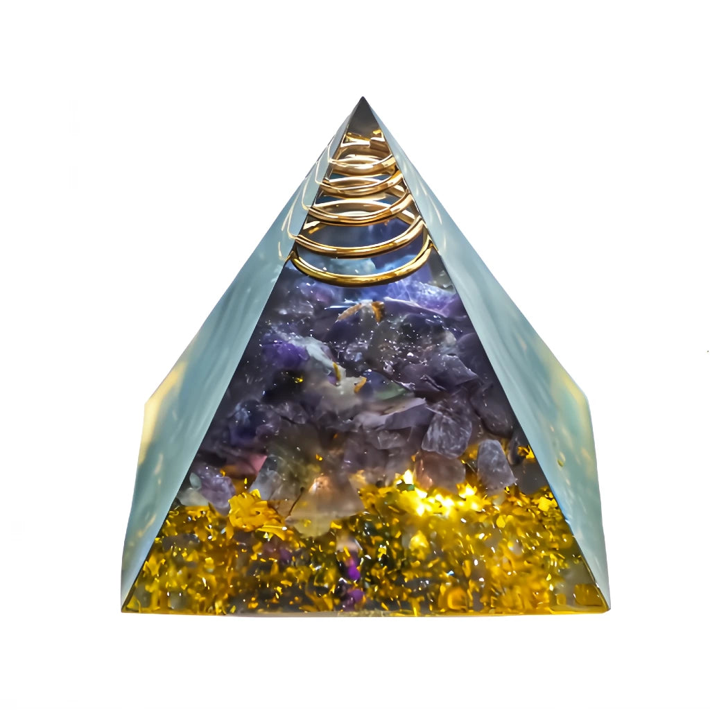Pyramid-shaped crystal orgone with gold coil, amethyst stones on a white background