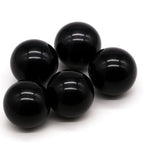 Five black spheres on a white background