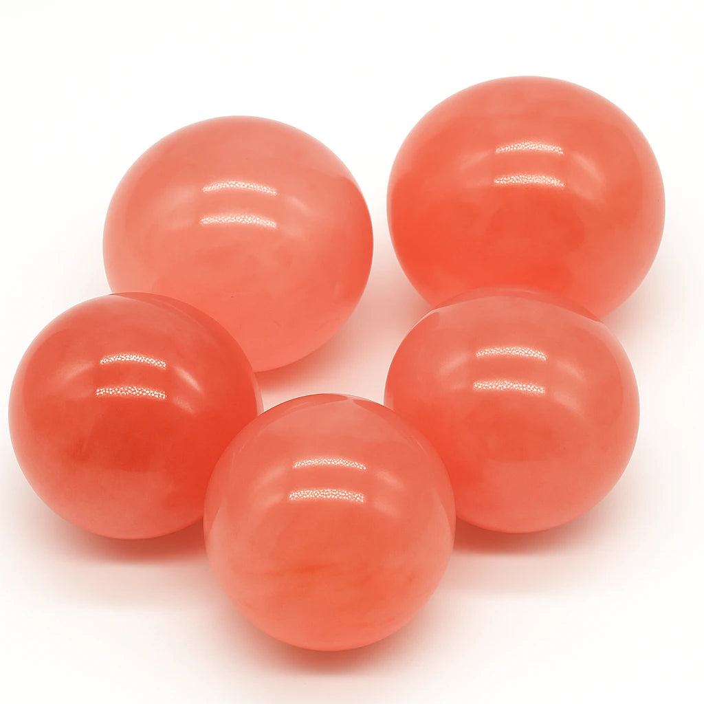 Five pinkish-orange spheres on a white background