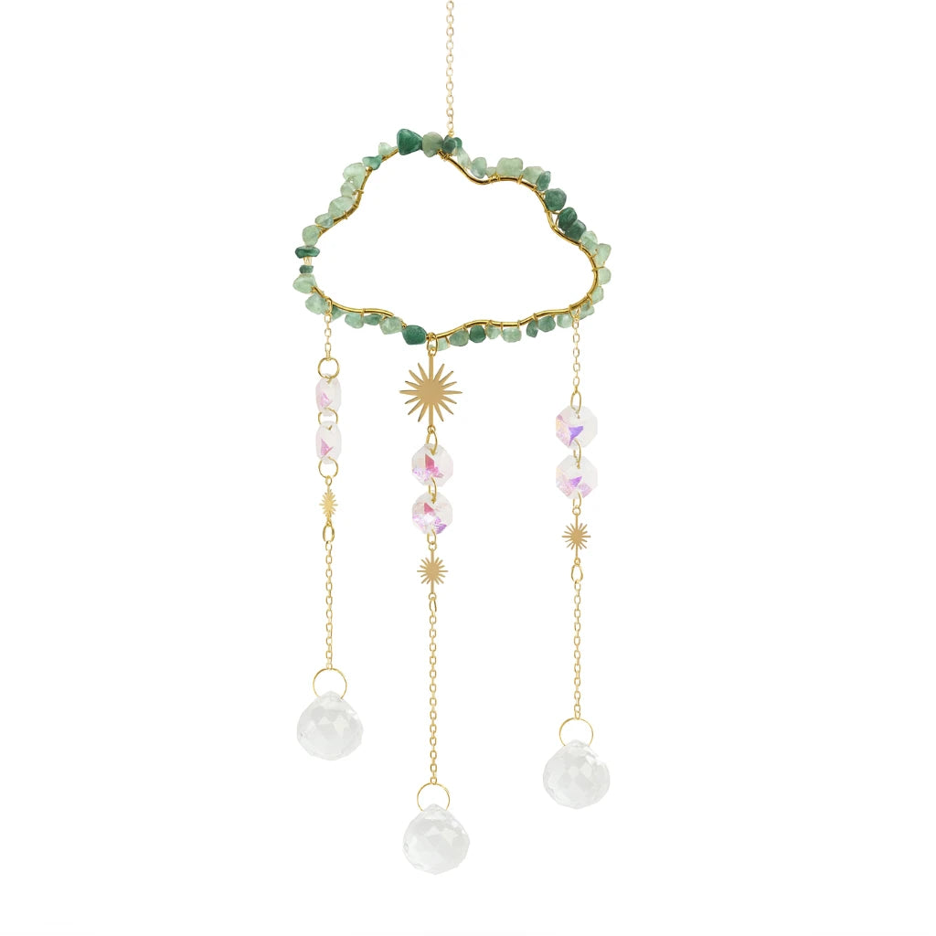Dreamcatcher with green beads, gold accents, and white pearls on a white background