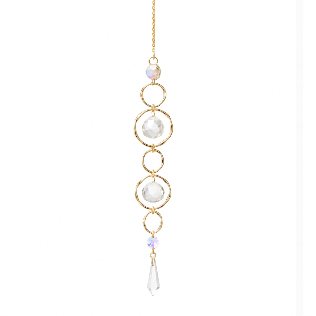 Gold necklace with three pearl-like beads and a clear crystal on a white background