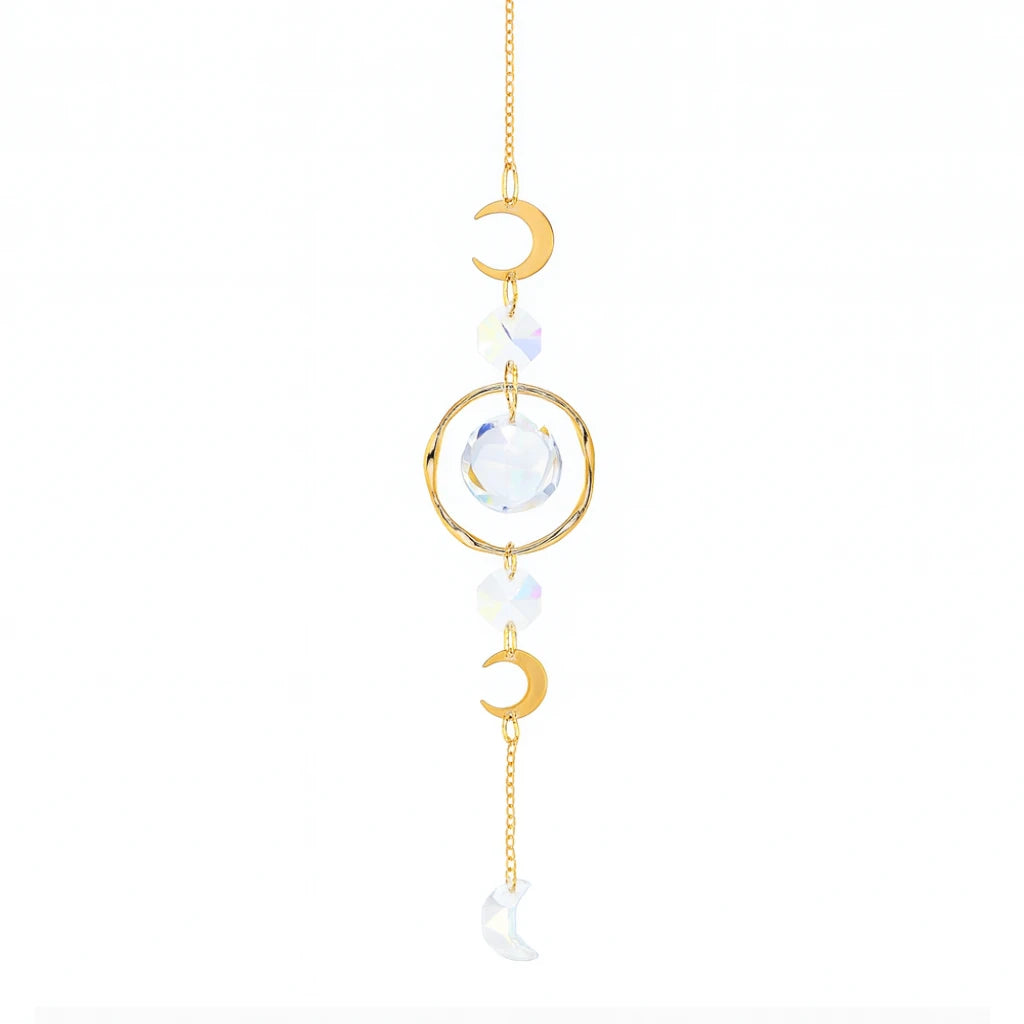 Decorative hanging ornament with gold crescent moons and clear crystal on a white background