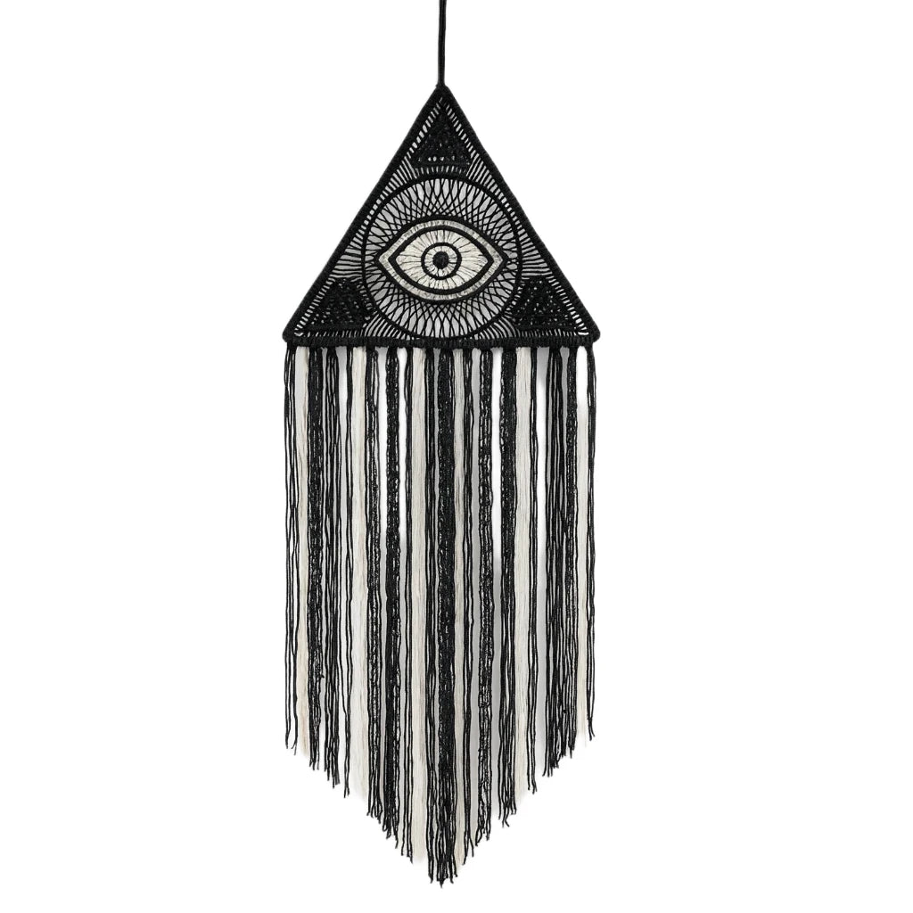 Decorative wall hanging with an eye design and fringes on a white background