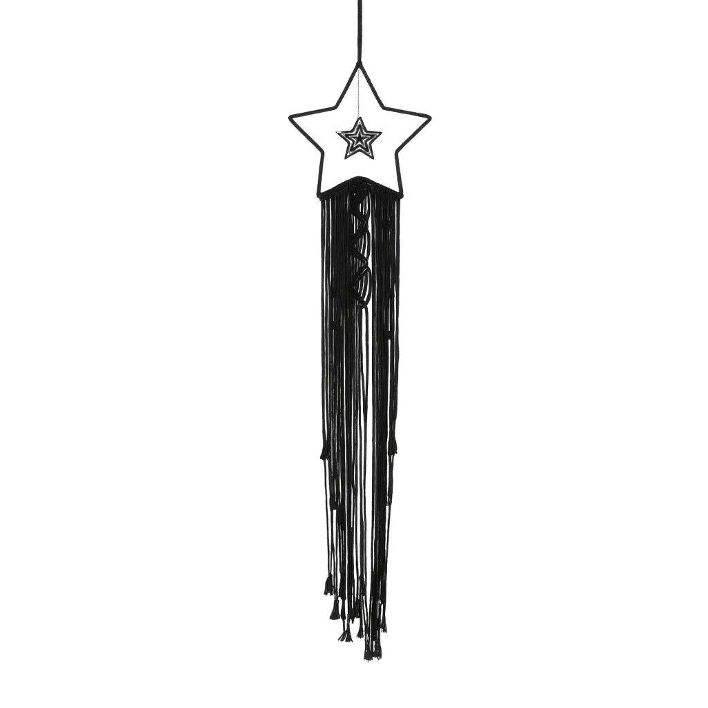 Black and white star-shaped hanging decoration with tassels on a white background