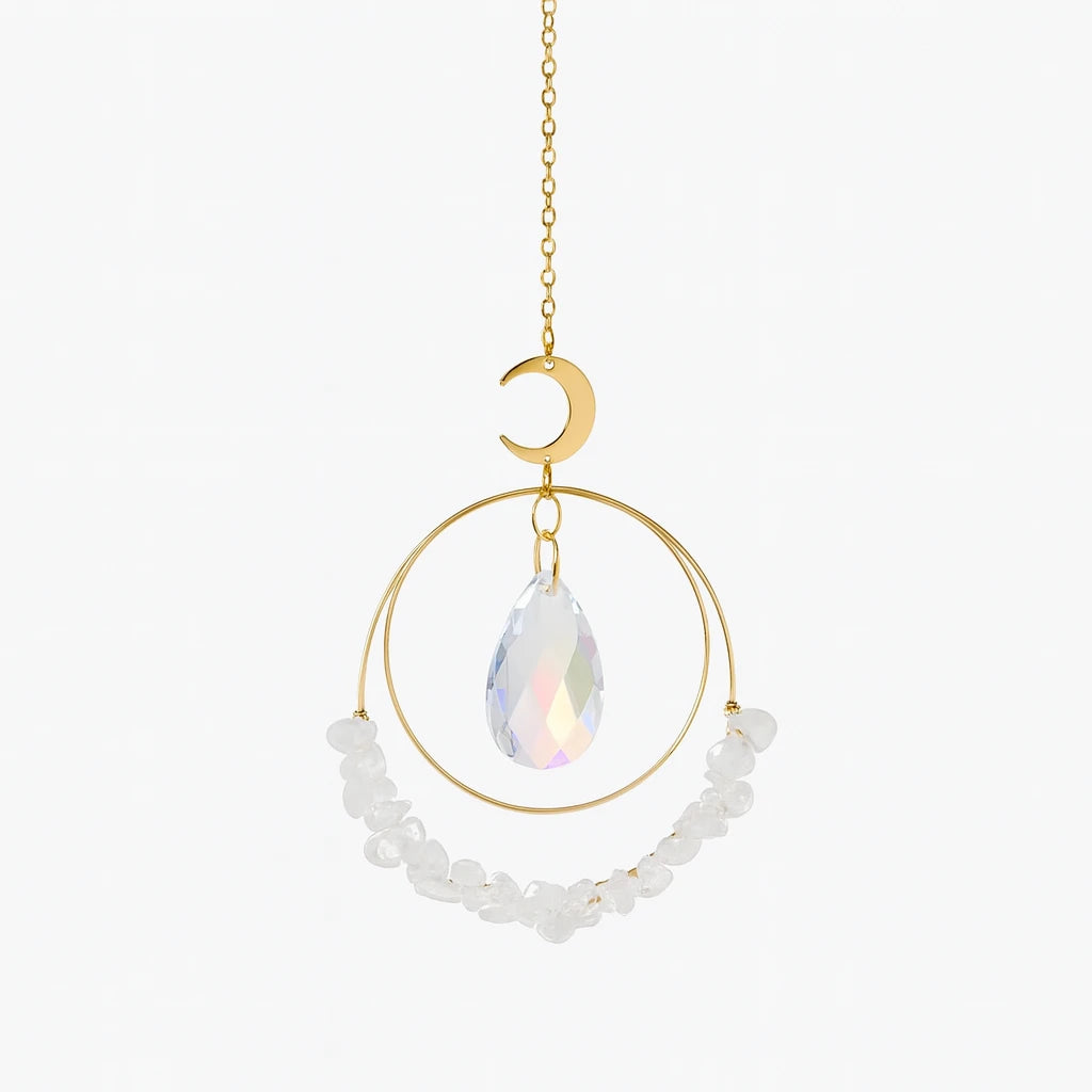 Decorative hanging ornament with gold chain, moon-shaped pendant, teardrop crystal, and white beads on a white background.
