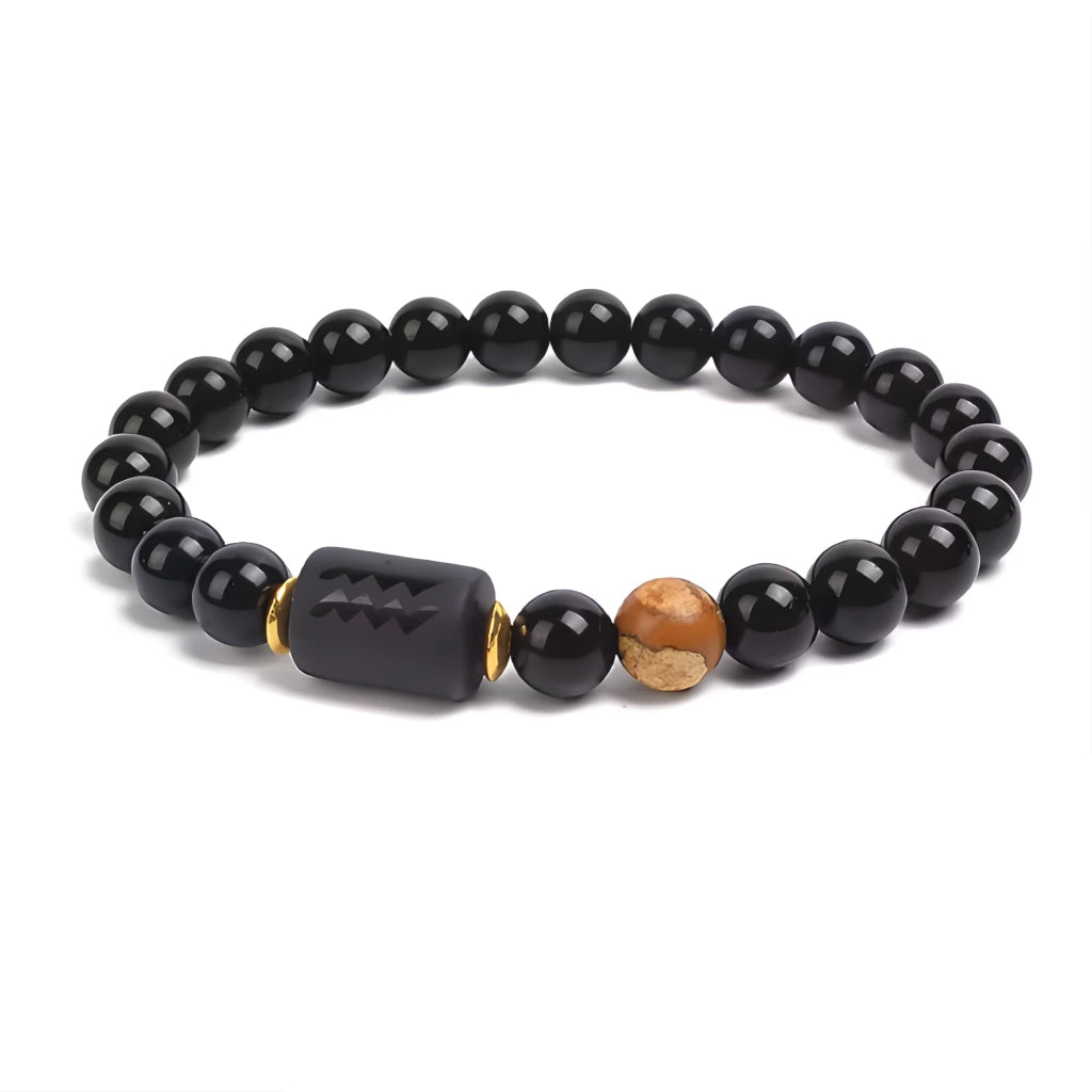 Black beaded bracelet with a unique charm and brown bead on a white background