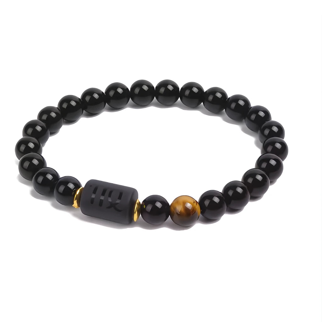 Black beaded bracelet with a unique charm on a white background