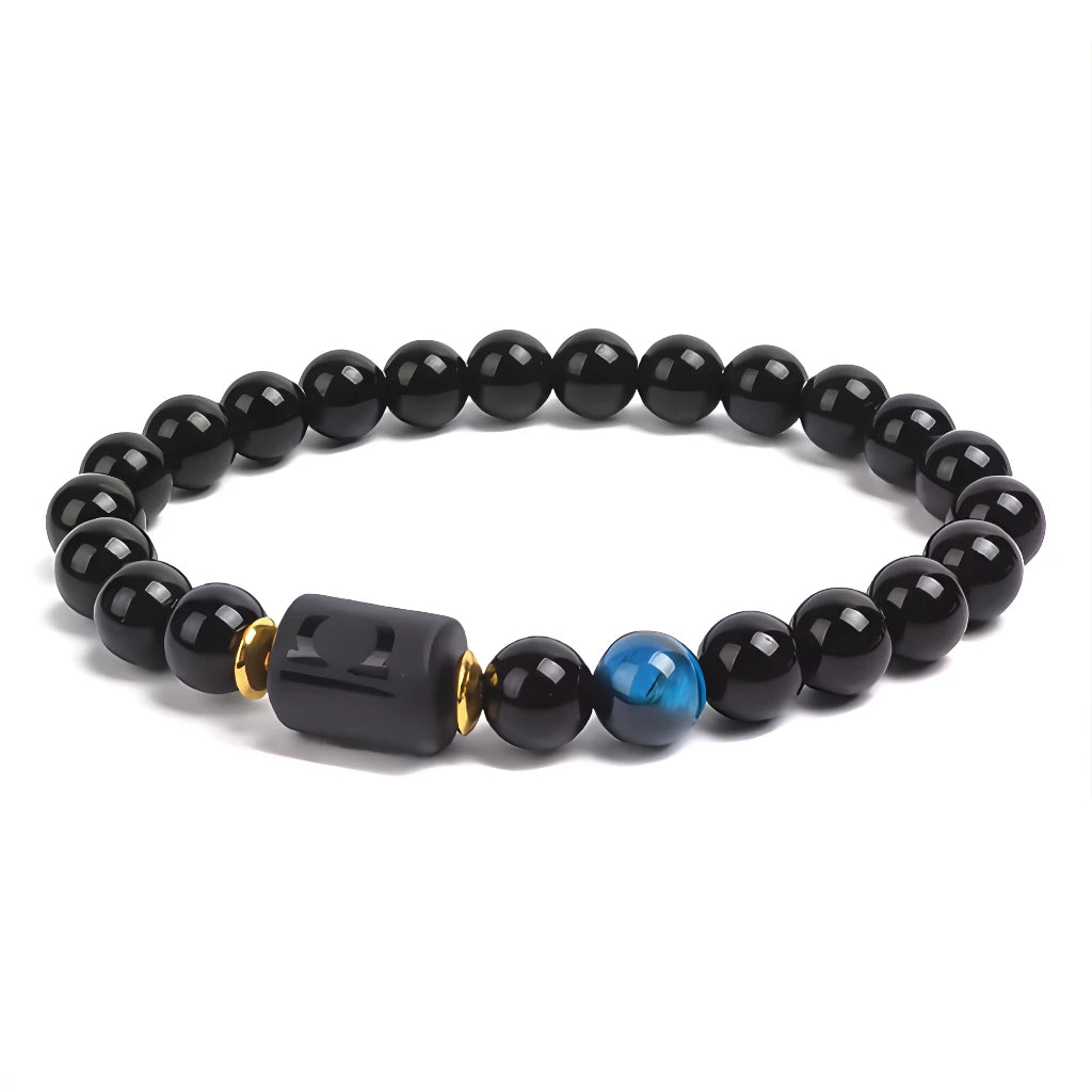 Black beaded bracelet with a blue accent bead on a white background