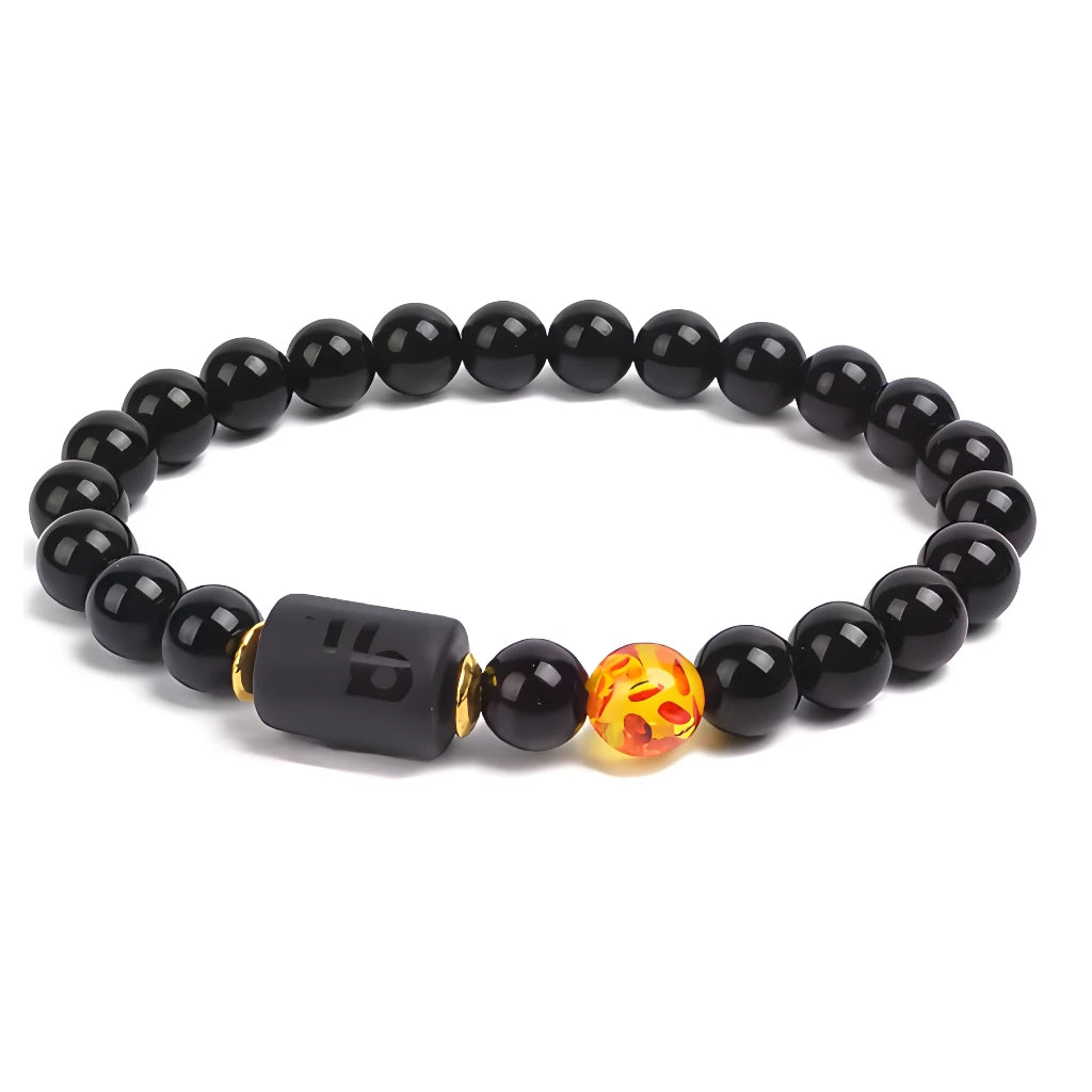 Black beaded bracelet with a unique orange bead on a white background