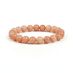 Orange beaded bracelet on a white background