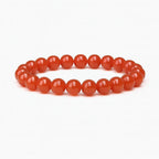 Red beaded bracelet on a white background