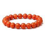 Orange beaded bracelet on a white background