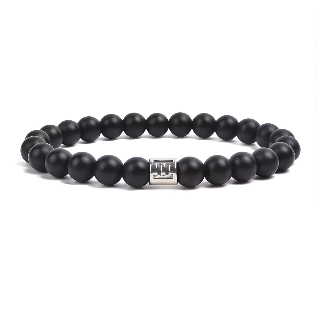 Black beaded bracelet with a silver clasp on a white background