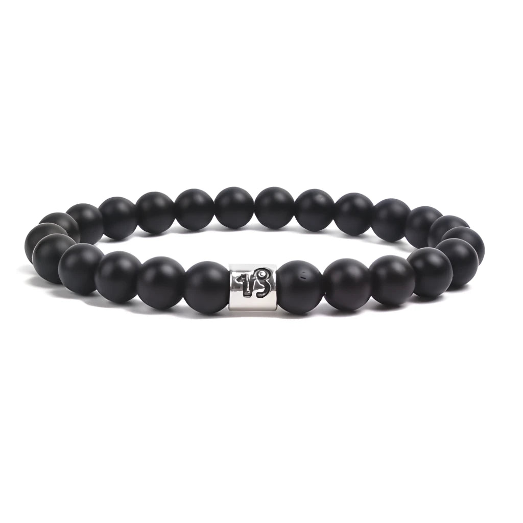 Black beaded bracelet with a silver clasp on a white background