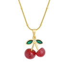 Cherry crystal gold necklace on white background 