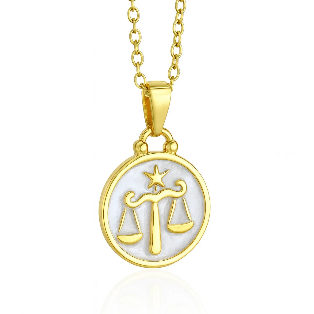 Gold necklace with Libra zodiac sign pendant on a white background
