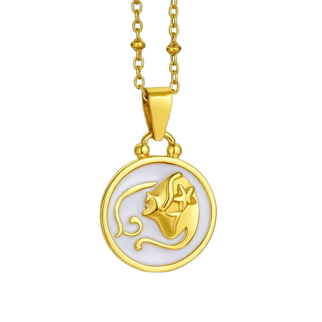 Gold necklace with a round pendant featuring a fish design on a white background