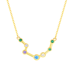 Gold necklace with a zodiac sign pendant featuring colorful gemstones on a white background