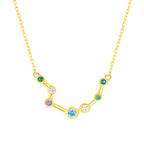 Gold necklace with a zodiac sign pendant featuring colorful gemstones on a white background