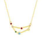 Gold necklace with a zodiac sign pendant featuring colorful gemstones on a white background