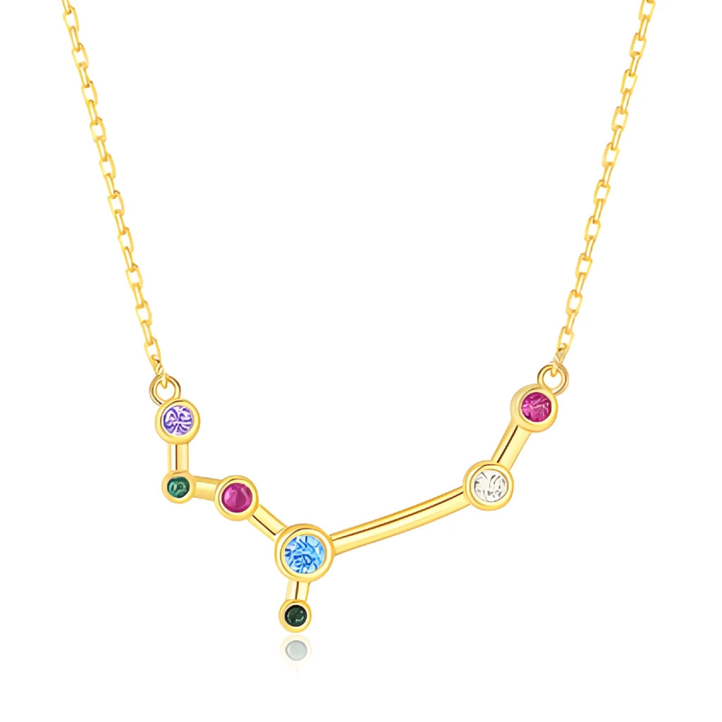 Gold necklace with a zodiac sign pendant featuring colorful gemstones on a white background