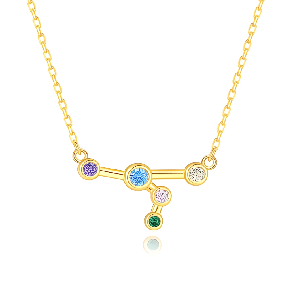 Gold necklace with a zodiac sign pendant featuring colorful gemstones on a white background