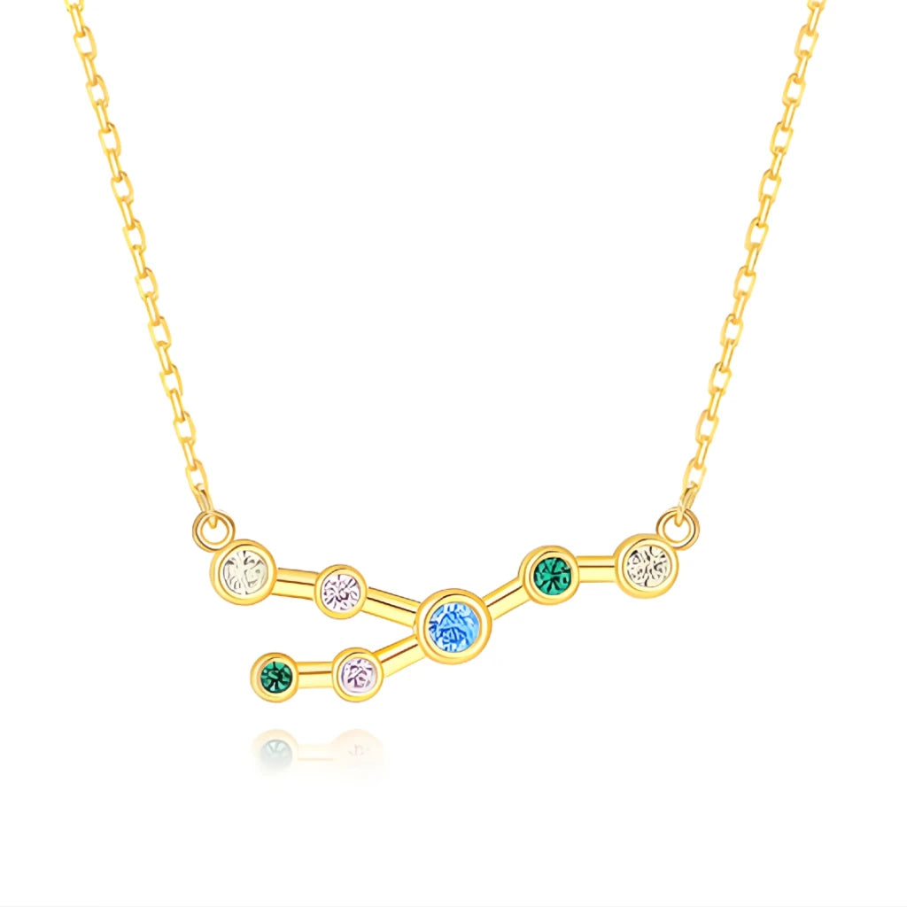 Gold necklace with a zodiac sign pendant featuring colorful gemstones on a white background