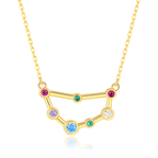 Gold necklace with a zodiac sign pendant featuring colorful gemstones on a white background